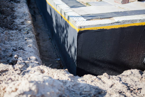 Professional Waterproofing technician working in Aurora, NY